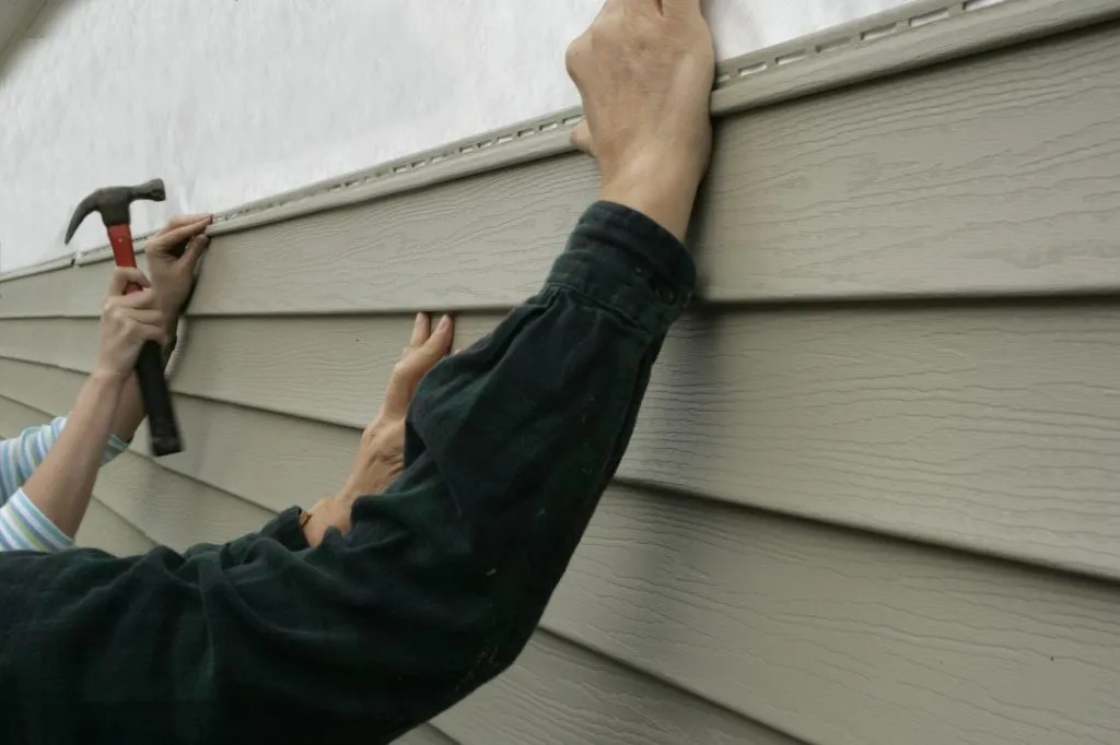 Lap siding installation with hammer